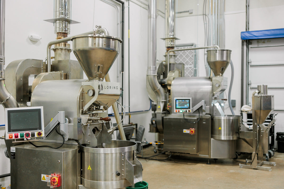 The 321 Coffee roastery and production floor features two large Loring brand coffee roasting machines.