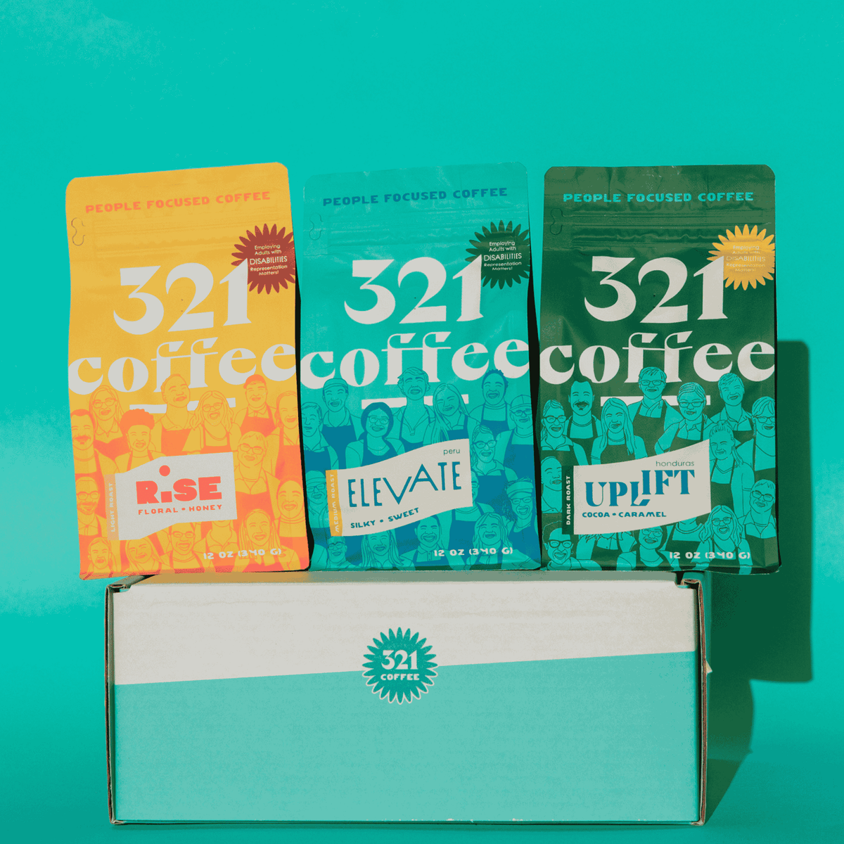 Three '321 Coffee' packages with different labels on a teal background