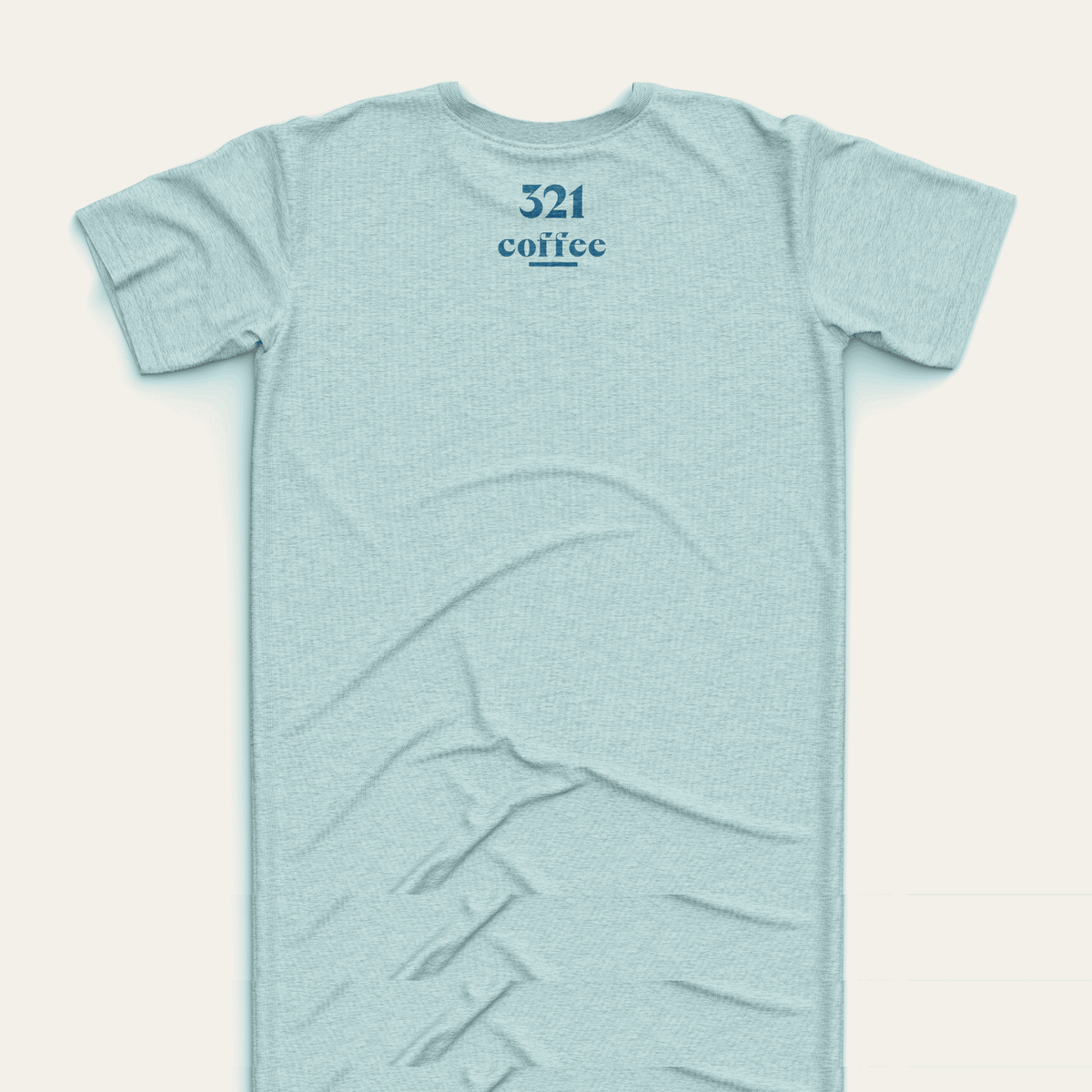 The back of a teal t-shirt showing "321 "Coffee" in blue located at the top of the shirt just under the collar.