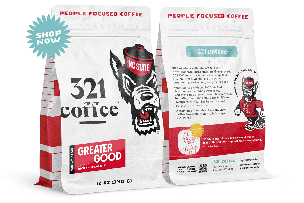 The front and bag renderings of the Greater Good bag of coffee are displayed side by side. The bag is white with black and red accents. The Mr. Tuffy wolf head accompanies the 321 Coffee logo on the front.