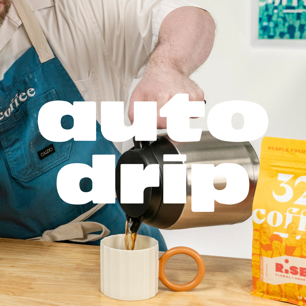 White text that reads "auto drip" overlays a picture of a barista pouring hot coffee into a cream mug.