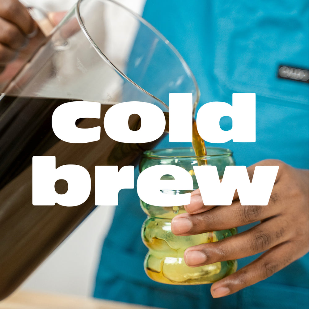 White text that reads "cold brew" overlays a photo of a barista pouring a pitcher of cold brew into a green glass.