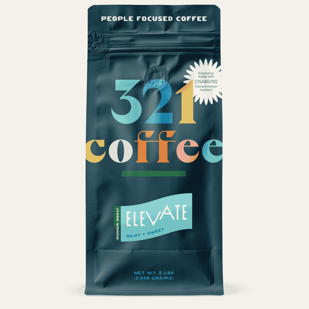 A navy blue bag with "321 Coffee" written in colorful letters. Below that, the blend name, Elevate, is written on a teal background.