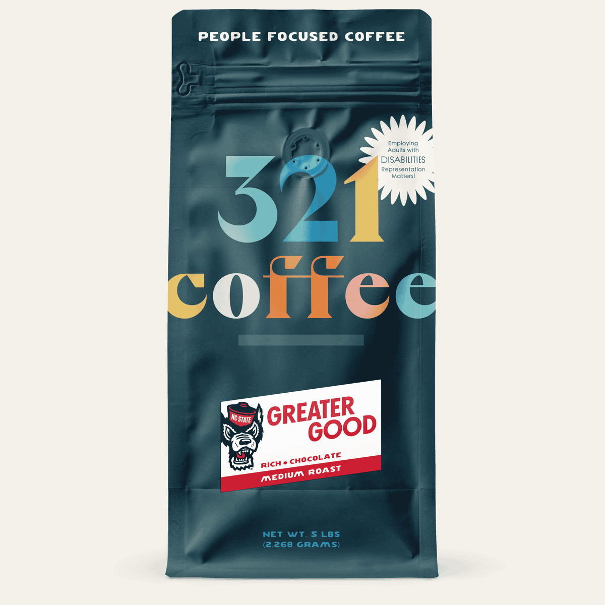 A navy blue bag with "321 Coffee" written in colorful letters. Below that, the blend name, Greater Good, is written on a white background.